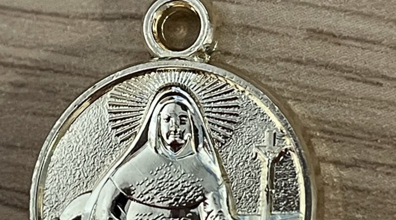 Why do Catholics wear medals of saints?